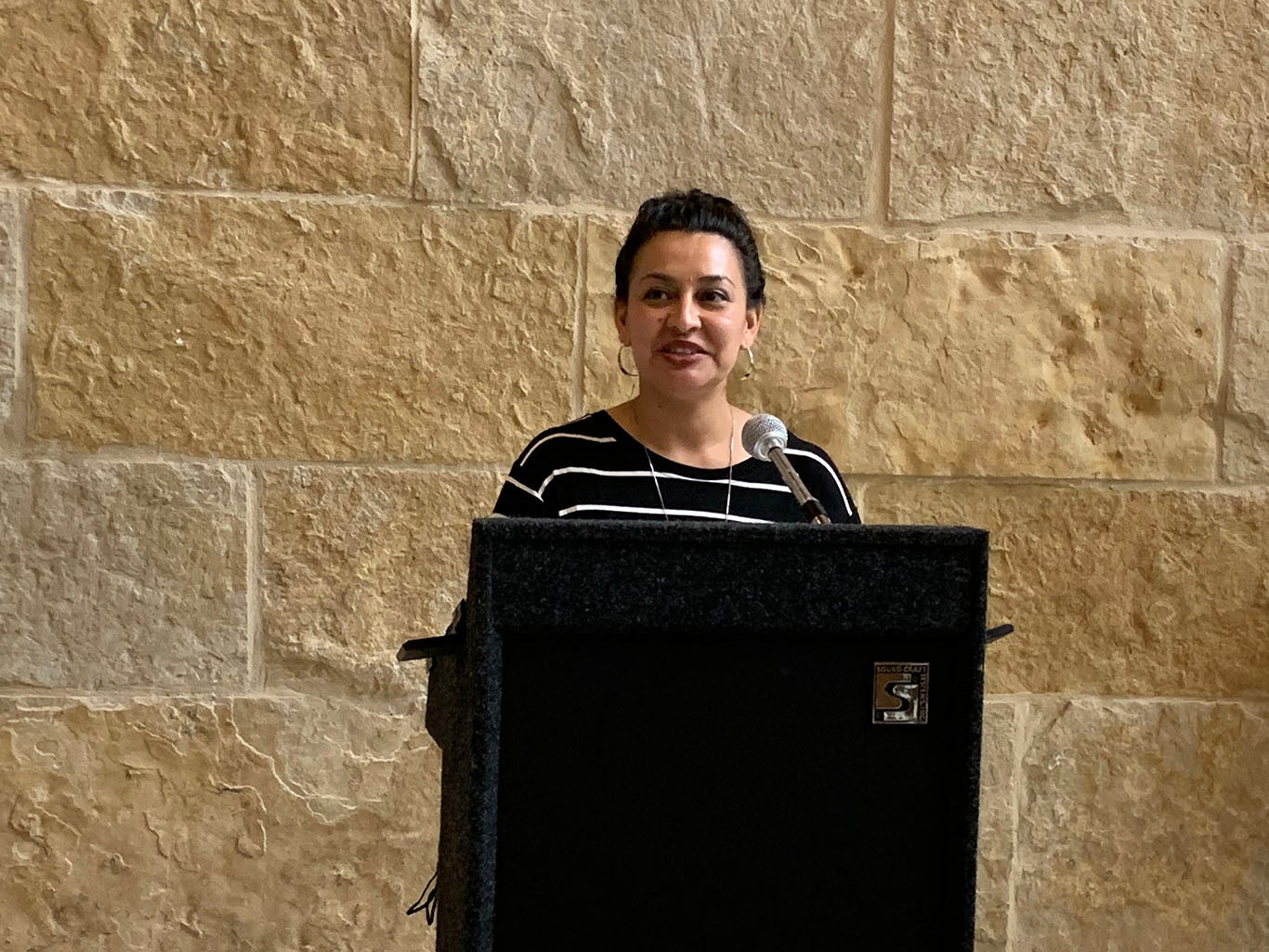 Miriam Solis speaks at the Austin Civilian Conservation Corps Photovoice Exhibition Reception. Photo Credit: Weston Rose