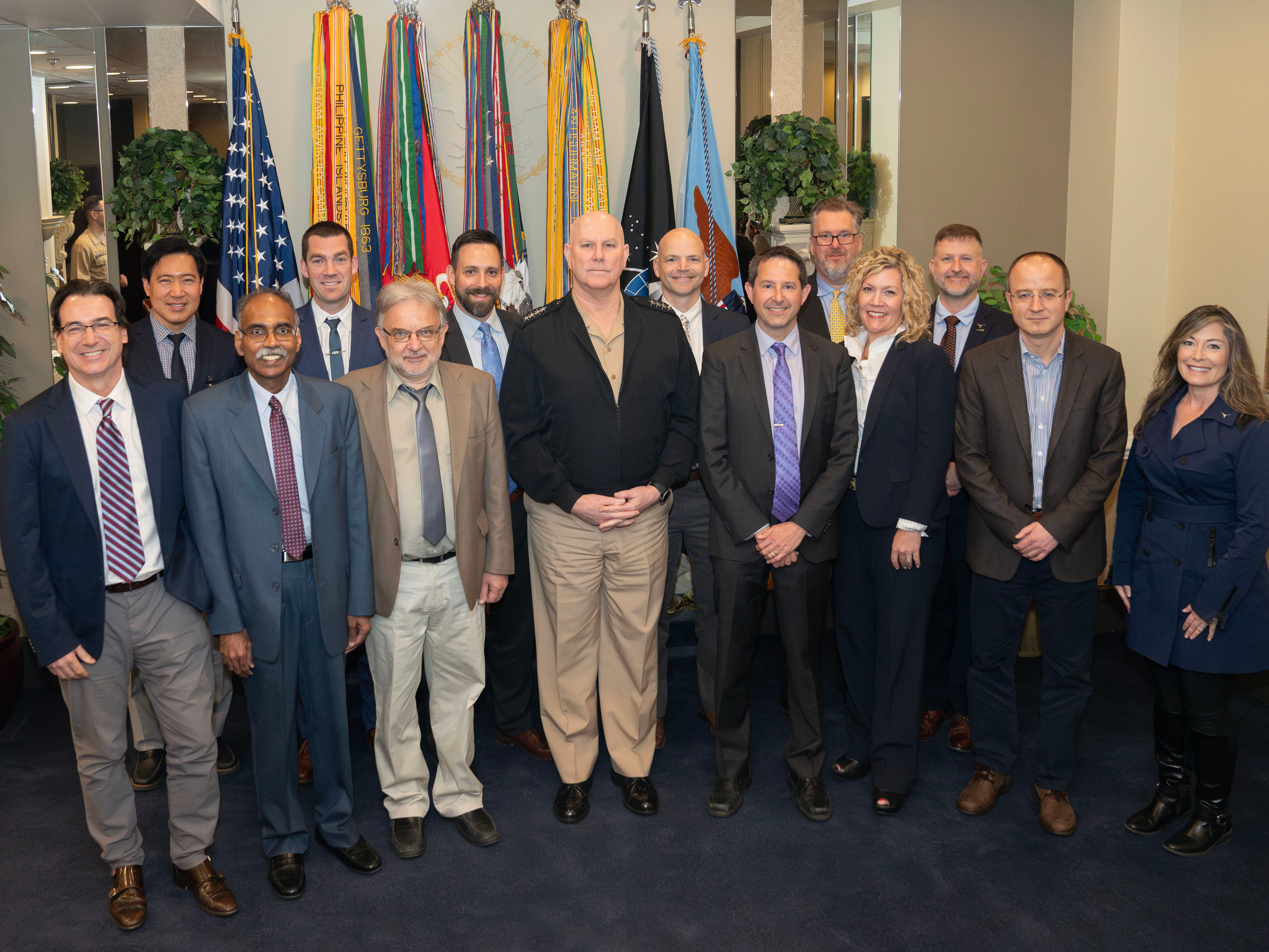 Good Systems’ Luis Sentis (far left), Matthew Lease (seventh from right) and Peter Stone (sixth from right) with Admiral Christopher W. Grady (front row, center)