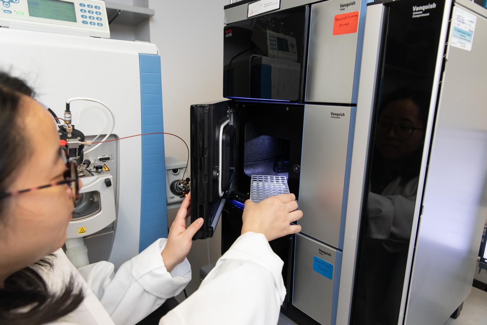 image of lab assistant using equipment
