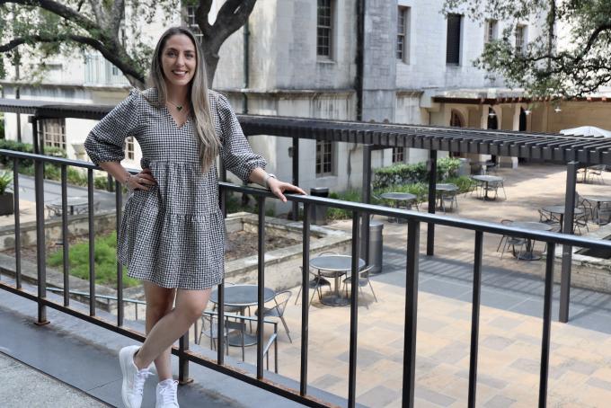 Karen Holguin standing outside the Flawn Academic Center at UT Austin